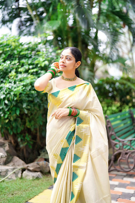 A Women wearing Golden Tissue Saree with Green Temple Motifs